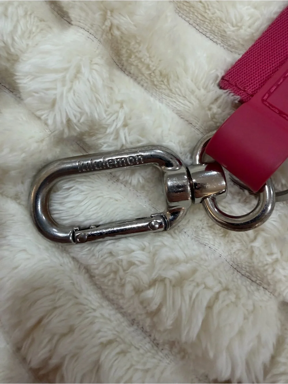 lululemon pink logo wristlet strap with orange lettering